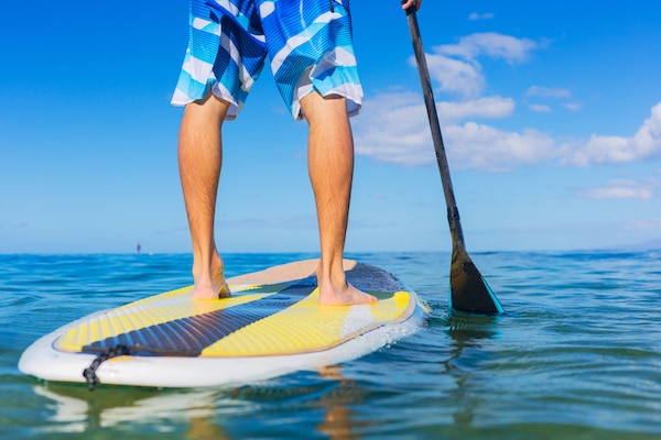 man on stand up paddle board P2J8VXQ Restaurants Coastal Living Devon